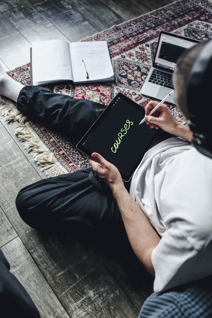 Builder working on a laptop from the floor